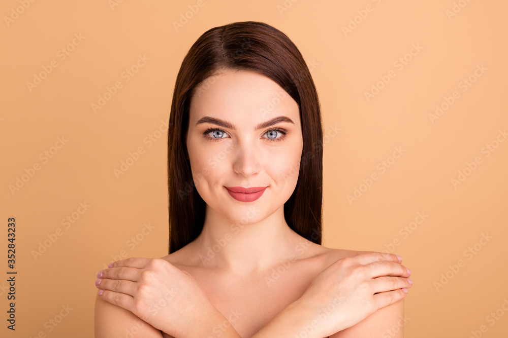 Close up photo of charming positive girl hug herself feel body harmony enjoy wellnes after salon skincare treatment isolated over beige color background - obrazy, fototapety, plakaty 