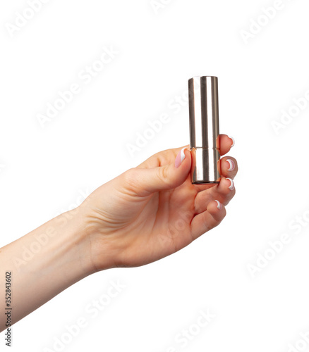 Hand holding lipsticks isolated on white background