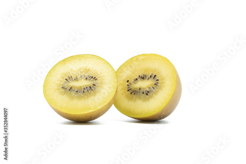 Cut in half golden kiwi fruit isolated on white background
