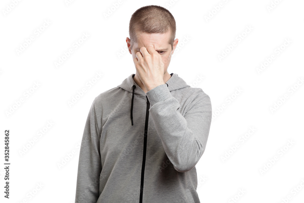 tired suffering man covered his face with his hand, with sadness and sorrow. Dressed in sportswear. Isolated tired suffering man covered his face with his hand, with sadness and sorrow. Dressed in sportswear. Isolated