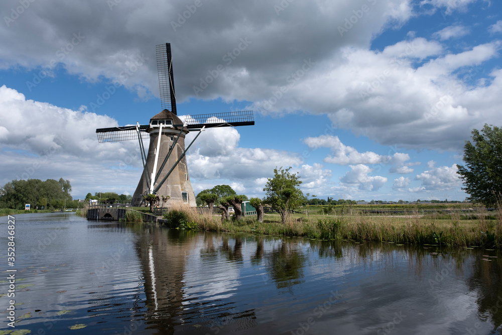 Traditional dutch windmill near the canal. Netherlands.