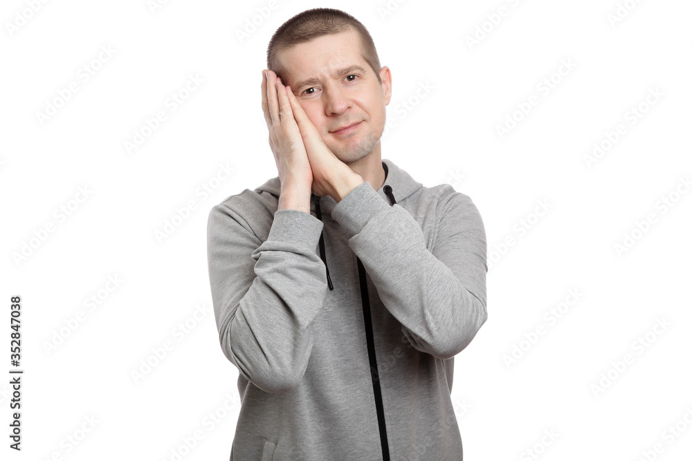 tired man put his hands under his head, wants to sleep. Dressed in sportswear. Isolated tired man put his hands under his head, wants to sleep. Dressed in sportswear. Isolated