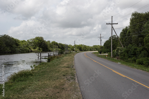 Curving roadway deep in the bayou of Louisiana on a cloudy day photo