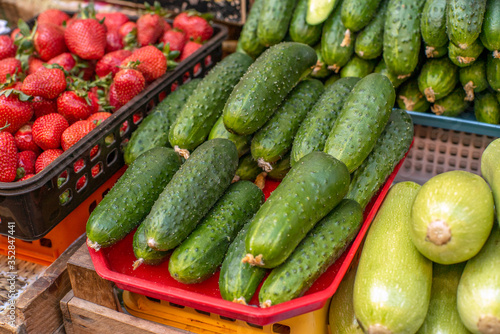 green cucumbers at the grocery market close up. Sale of products.