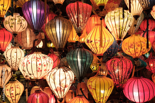 Magical Chinese multi color lanterns hanging in an outdoor store. 