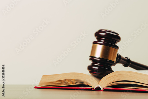 Judge gavel and laws books on a wooden table.