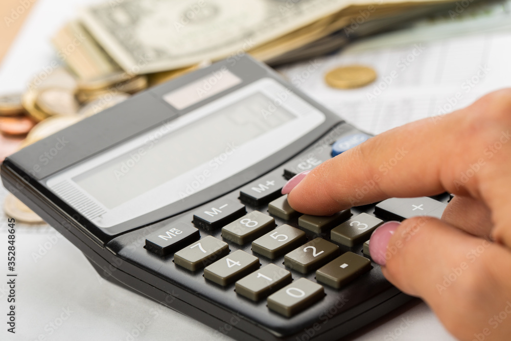 Coin money and banknote bills with a calculator. ballance reduction Coin money and banknote bills with a calculator. ballance reduction