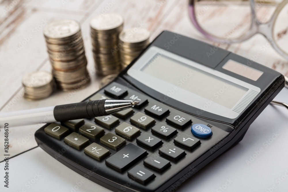 Coin money and banknote bills with a calculator. ballance reduction Coin money and banknote bills with a calculator. ballance reduction