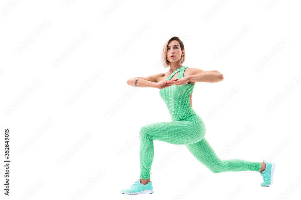 Obraz premium full body portrait of young sporty woman stretching before exercise isolated on white background.