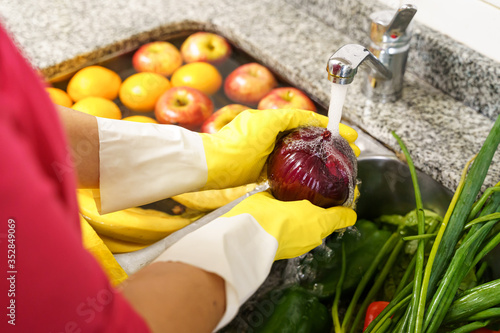 Cleaning fruits and vegetables with latex gloves for coronavirus