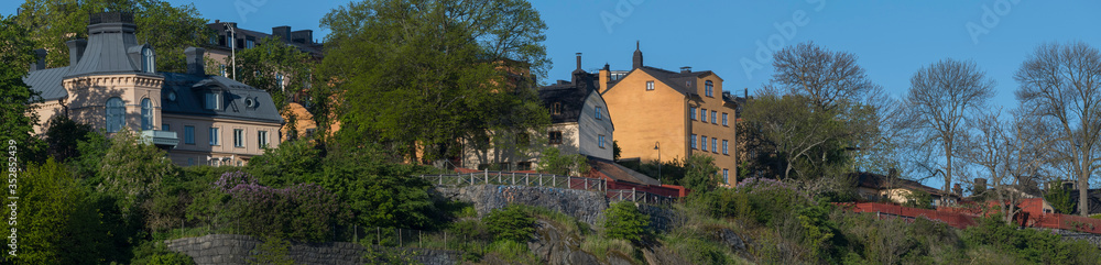Sunny morning view over old house part of the district of Södermalm, above the waterfront at the bay Riddarfjärden and the sluice part in Stockholm. Sunny morning view over old house part of the district of Södermalm, above the waterfront at the bay Riddarfjärden and the sluice part in Stockholm.