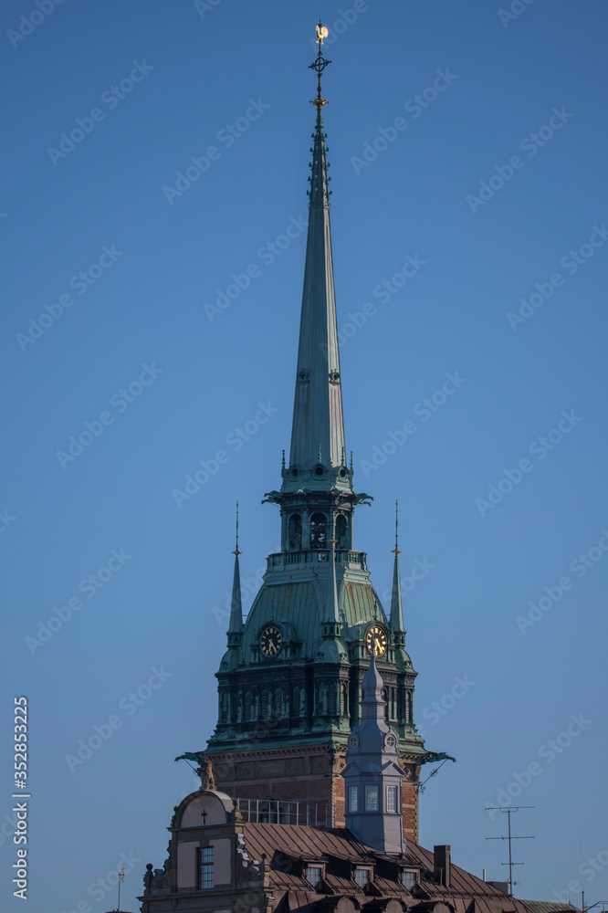 The church tower of the German church and old houses a sunny spring morning in the old town Gamla Stan in Stockholm