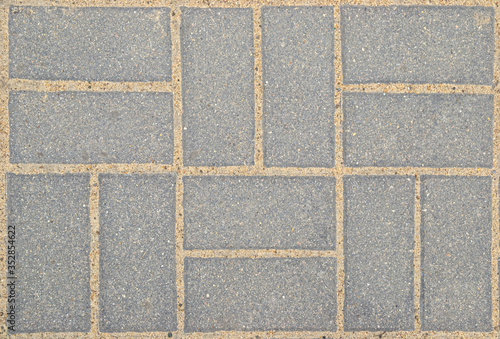 Paving stones sidewalk gray background abstraction. top view, mockup.