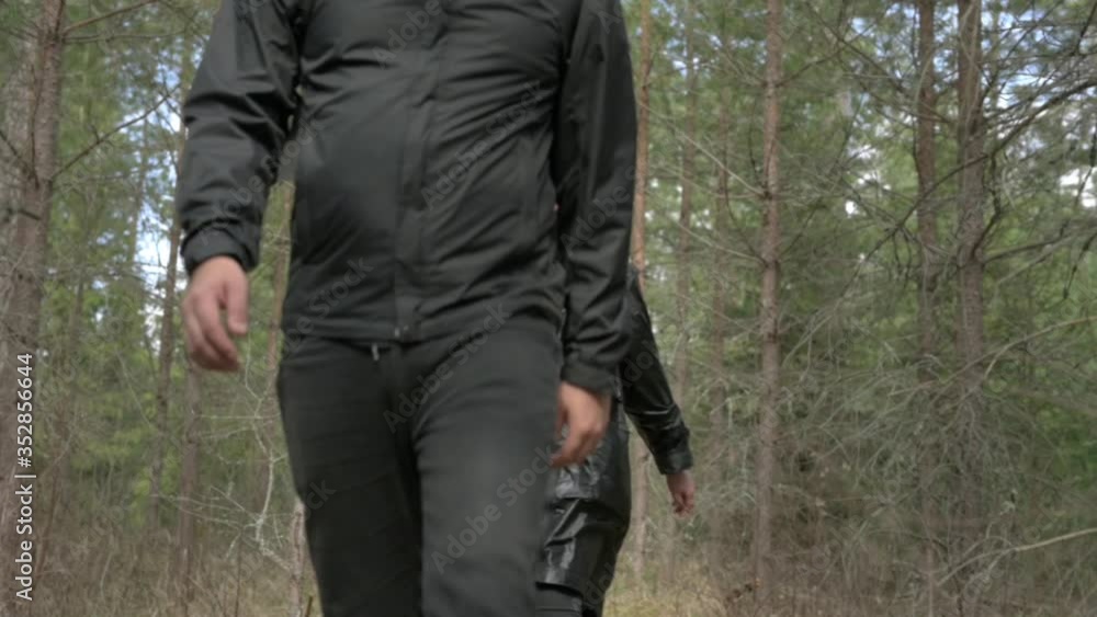 Close up look on hiking boots crossing fallen tree. Men hiking in forest with black boots.
Close up look on hiking boots crossing fallen tree. Men hiking in forest with black boots.