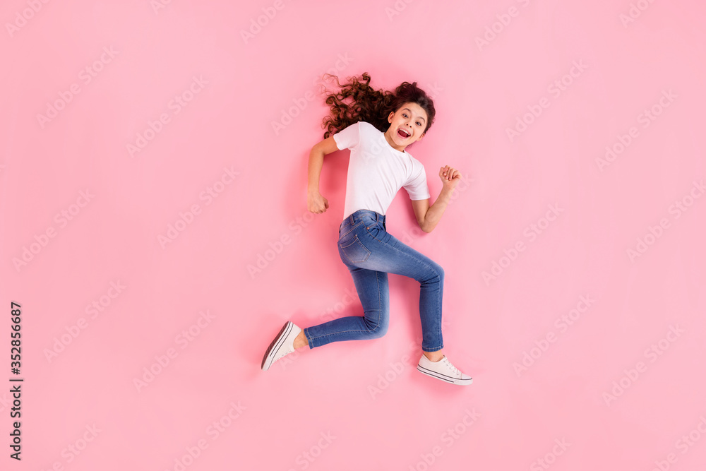 Top view above high angle flat lay flatlay lie concept full length body size view of her she nice lovely cheerful wavy-haired girl jumping running having fun isolated on pink pastel color background