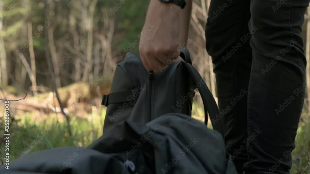 Men closing his backpack zipper and taking out jacket. Then grabs the backpack and leaves.
Men closing his backpack zipper and taking out jacket. Then grabs the backpack and leaves.