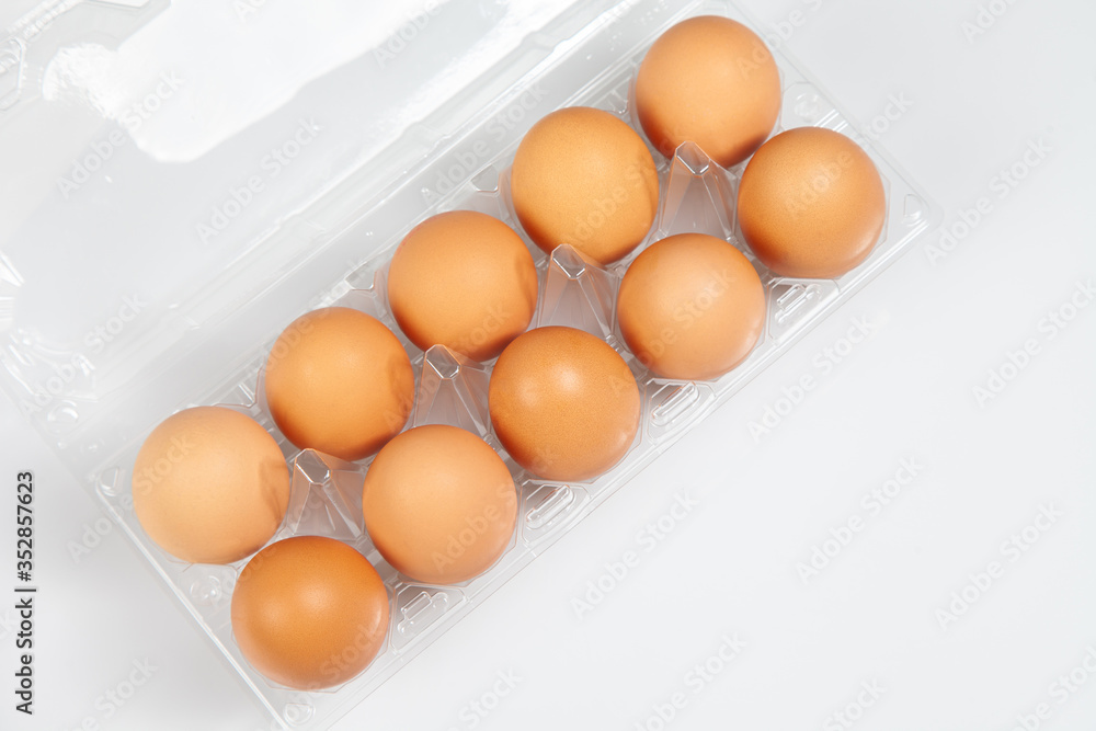 Eggs in box on white background. Fresh chicken eggs in Plastic packaging with copy space . Eggs in box on white background. Fresh chicken eggs in Plastic packaging with copy space .
