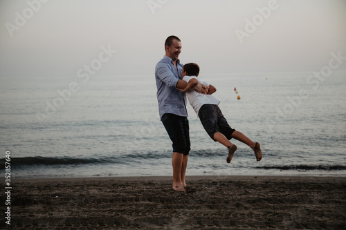 Father with son playing on the beach. Father's Day!