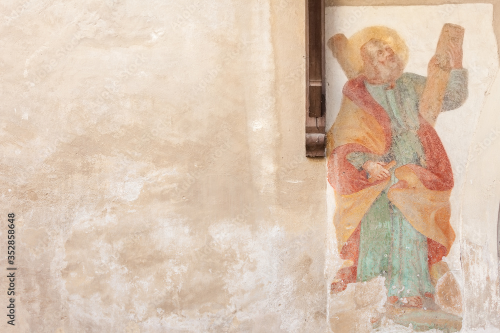 Naklejka premium Fresco outside the wall of San Andrea church. It is a Gothic building dating back to the 15th century, with subsequent Baroque additions