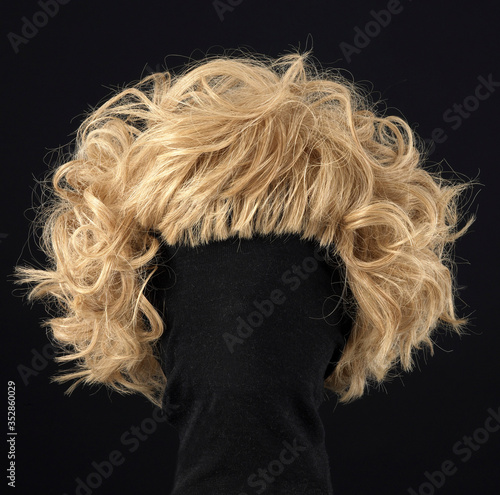 wavy blond hair wig isolated on black background