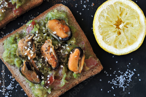 Healthy toasts with avocado pasta and mussels. Proper nutrition. Healthy breakfast or snack.