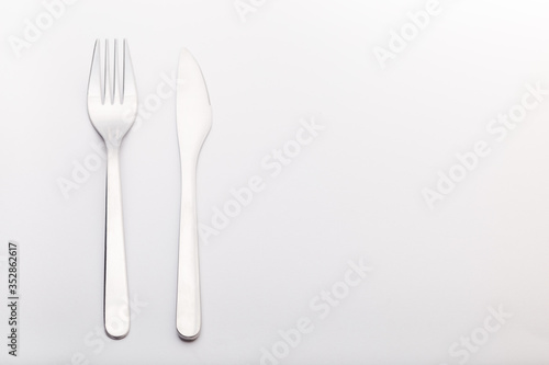Silverware set knife and fork on a gray background, horizontal, copy space