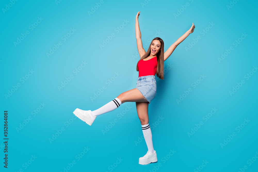 Full size photo of excited enthusiastic girl enjoy spring free time holiday raise hands scream wear casual style hipster look clothes shoes isolated over blue color background
