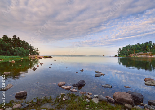 Summer walk along the Gulf of Finland on a wonderful calm morning in Lauttasaari next to the beautiful stones of Finnish nature.