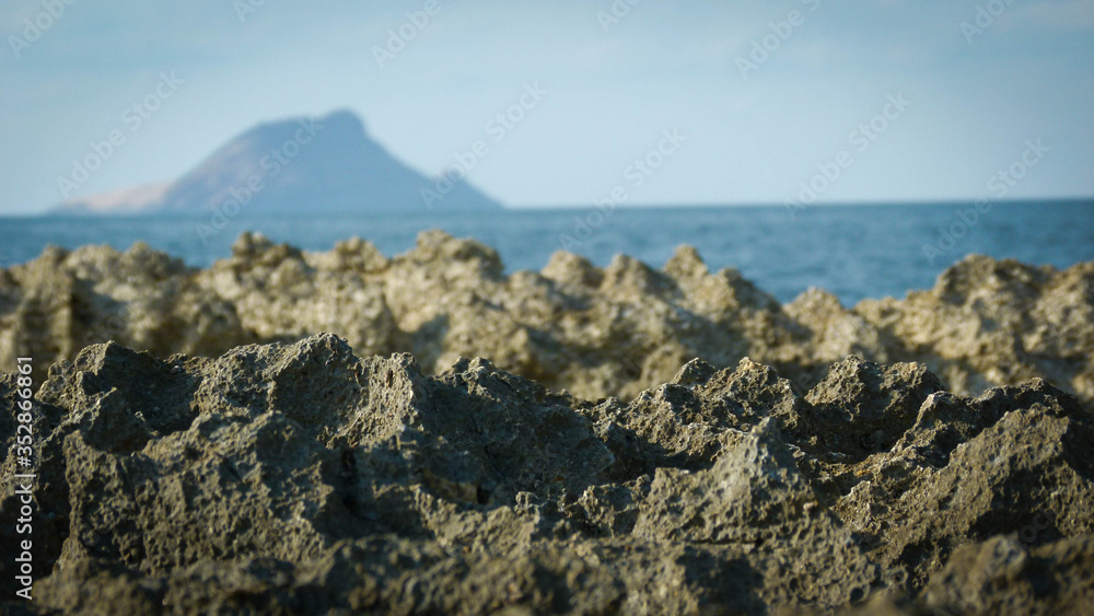 A close up of rocks and island in behind