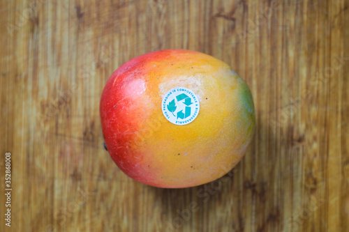 This Packaging is Compostable and Biodegradable. Concept image,Mango with recycling label