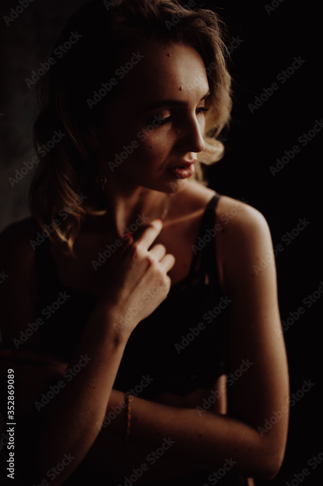 Dark portrait of sexy glamour woman wearing in elegant black lingerie Dark portrait of sexy glamour woman wearing in elegant black lingerie