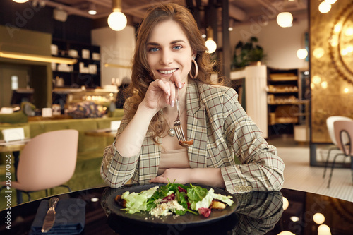 Young beautiful smiling woman eating healthy food © micro
