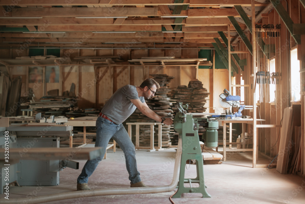 Man working in carpentry workshop. Machine assisted woodwork. Man working in carpentry workshop. Machine assisted woodwork.
