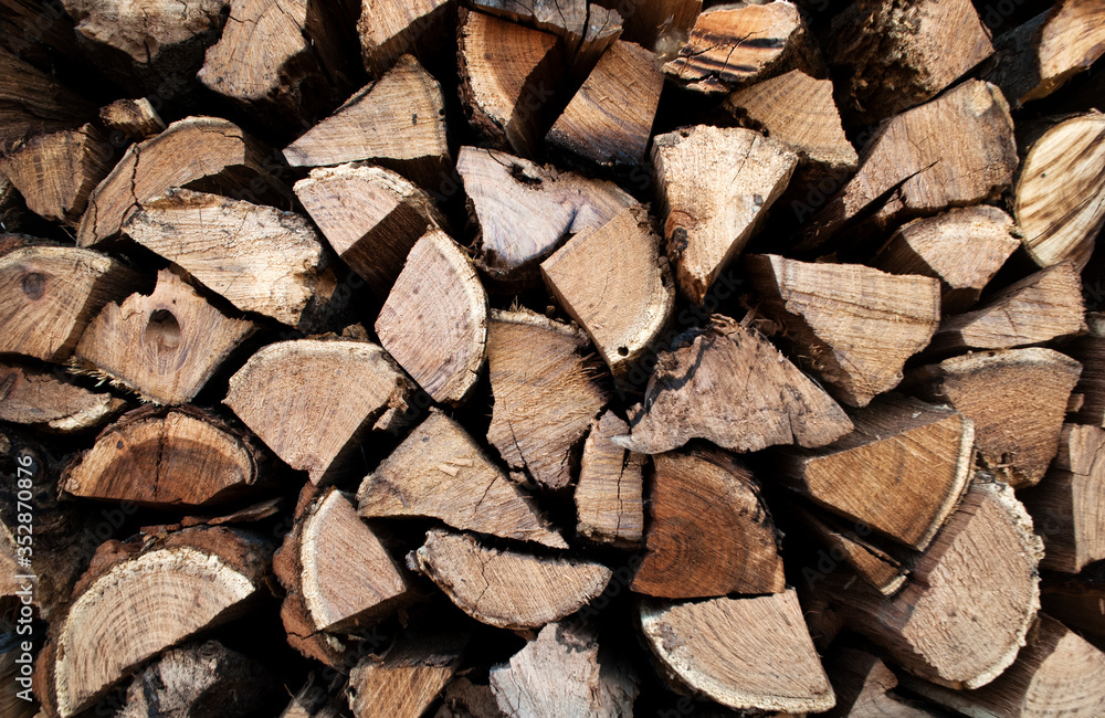 Harvested firewood. Stack of wood logs, wooden abstract background. Harvested firewood. Stack of wood logs, wooden abstract background.