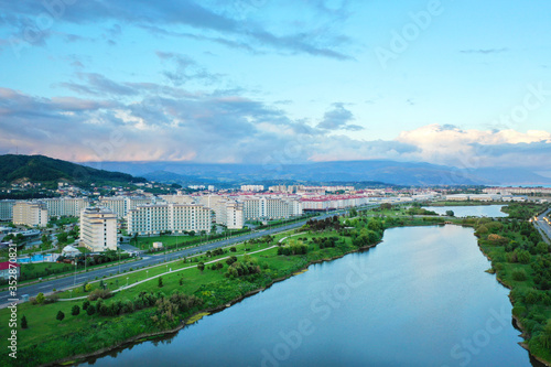 Imeretinskiy district, Sochi, Russia. Aerial view of the city park and lake at sunset