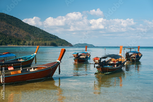 Long tail boats on tropical beach in Thailand