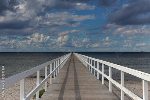 Endless pier with a beautiful sky in Malmo, Sweden. View of endless pier that goes into the North sea.