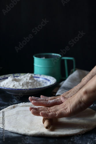 Dough ,making dough with flour on a black background, bread and pizza dough