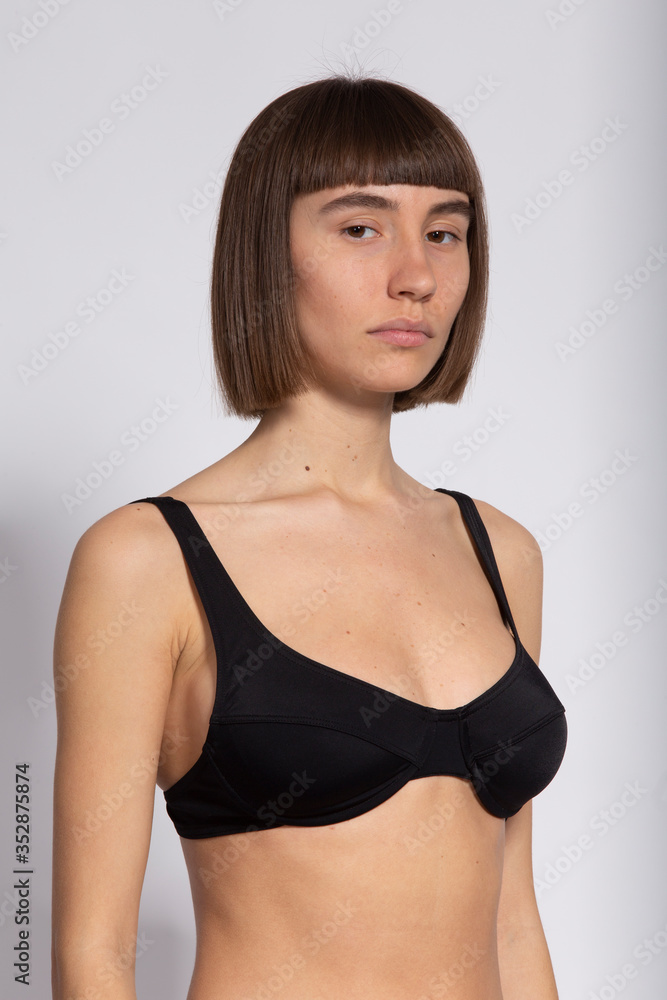 model snap portrait in black bra on white background model snap portrait in black bra on white background