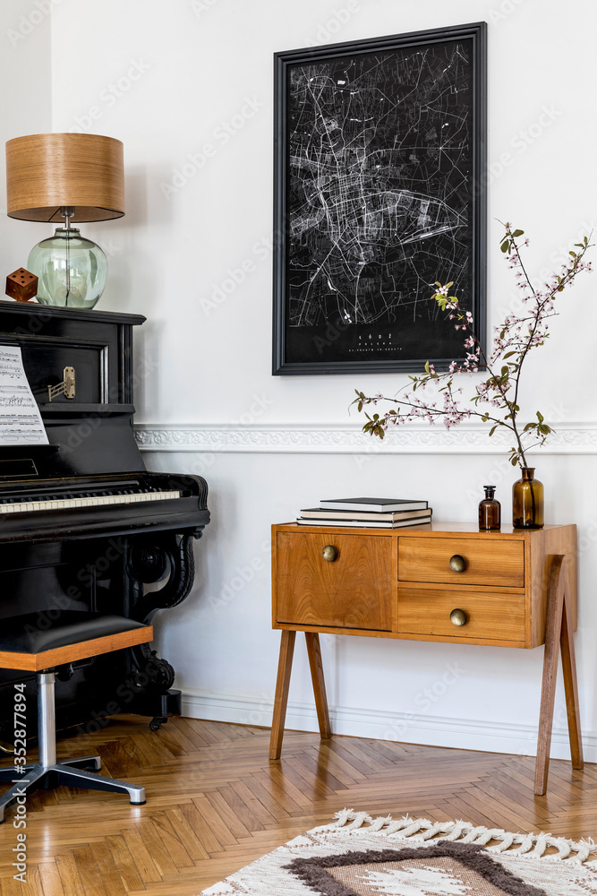 Modern composition of home interior with stylish black piano, design  cabinet, carpet, flower, lamp, decoration, mock up poster map and elegant  personal accessories in stylish home decor. Photos | Adobe Stock
