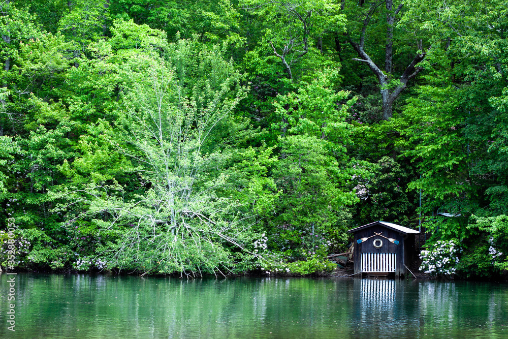 Boathouse on calm blue lake