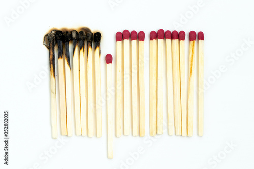 Burnt matches and whole matches on white background. One whole match isolated to stop the fire for stop destruction or rumor concept