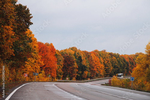 Colorful highway in Poltava region, Ukraine. Autumn red, green and orange road landscape.
