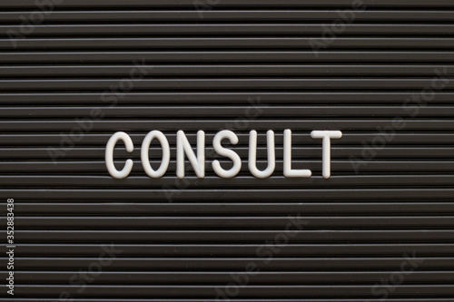 Black color felt letter board with white alphabet in word consult background