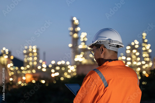 Engineer checks shipment of chemicals at oil and gas industry pipeline job site.