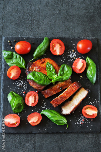 Meat steak with basil and cherry tomatoes. Paleo. Pegan. Keto diet.
