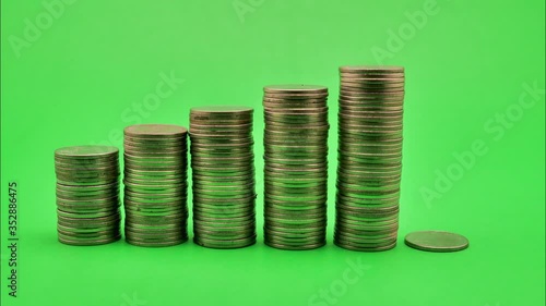 Money coins stack on green background, Stop Motion.