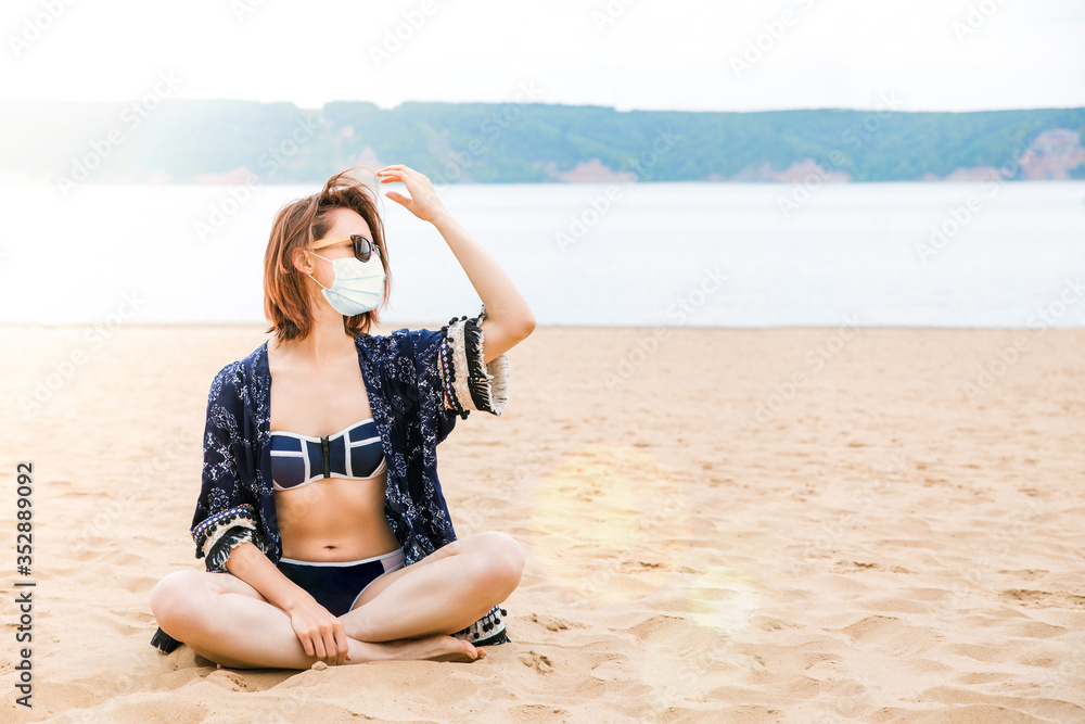 Beautiful European girl on an empty beach in a bikini and a light summer Cape Beautiful European girl on an empty beach in a bikini and a light summer Cape