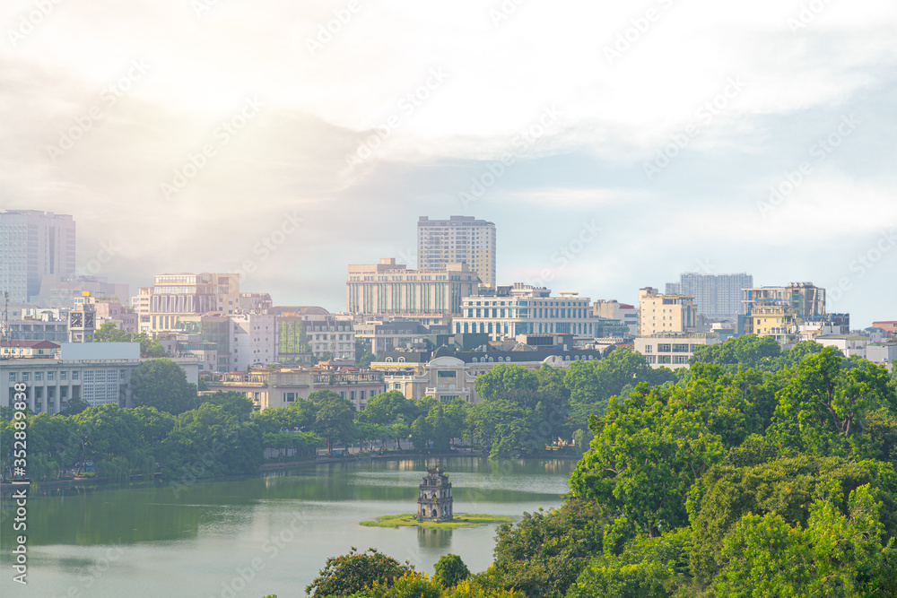 OLD QUARTER, HANOI/VIETNAM Landmark in city and top view of The Huc bridge and Ngoc Son temple or pagoda good culture. Lake of the Returned Sword, Hoan Kiem Lake in the morning time the sunset.