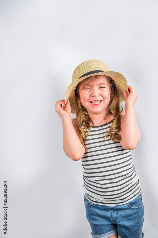 Summer vacation and holiday concept. Cute little smiling girl in a summer hat with sunglasses. Background for vacation banner, mockup Summer vacation and holiday concept. Cute little smiling girl in a summer hat with sunglasses. Background for vacation banner, mockup